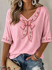 Damen-T-Shirt mit rosa Schleife und floralem Kunstprint