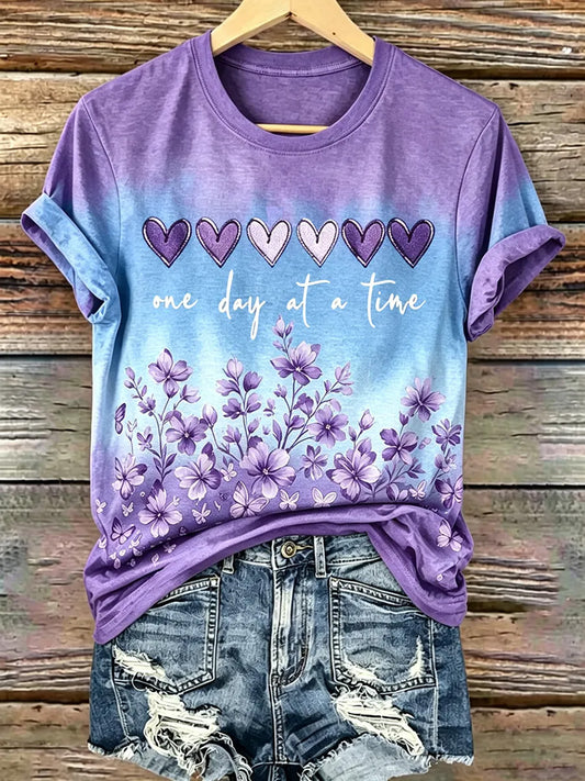Damen-T-Shirt mit lila Blumenmuster und Aufdruck zur Sensibilisierung für die Alzheimer-Krankheit